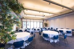 Haas Conference Center with a number of round tables surrounded by chairs