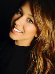 Zoe Rappaport head shot wearing black against a black background.