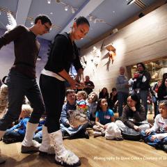 puppeteers acting in front of a group of children seated on the floor in front of Noah's Ark