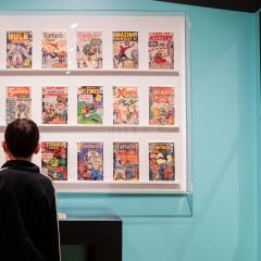 Two people view the exhibition Jack Kirby: Heroes and Humanity.